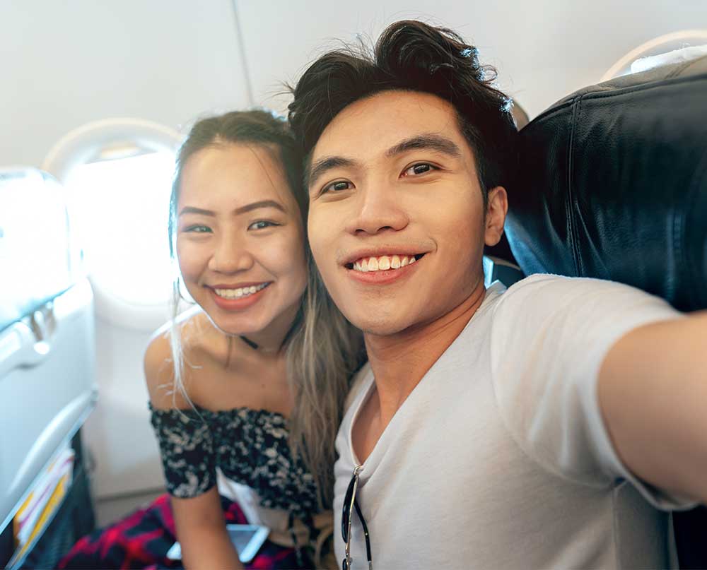travelers taking selfie on the plane