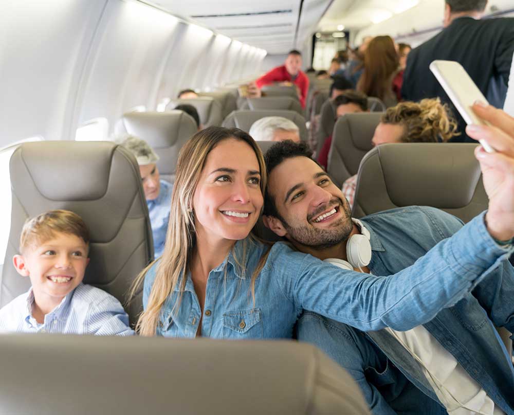 family taking airplane selfie