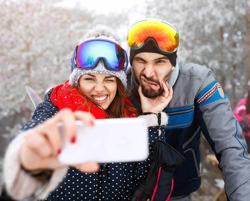 Skiers taking silly selfie